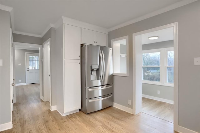 kitchen with crown molding, white cabinets, stainless steel refrigerator with ice dispenser, and light wood-type flooring