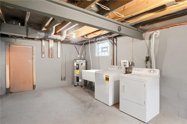 clothes washing area featuring washing machine and clothes dryer, water heater, and sink