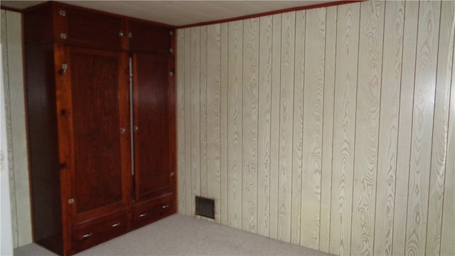 unfurnished bedroom featuring wooden walls