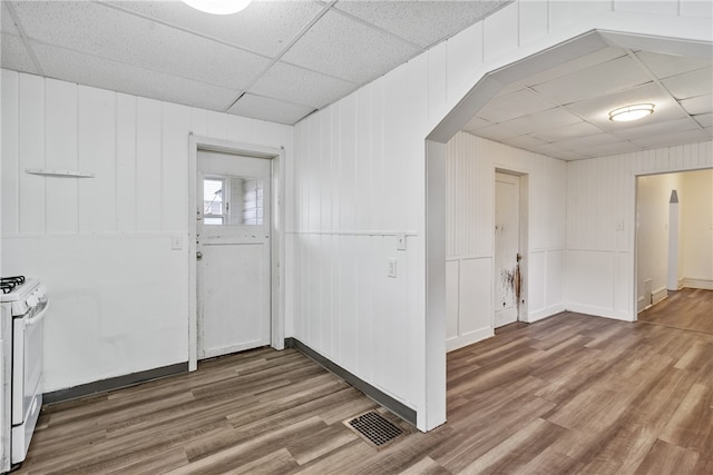 entrance foyer with wood-type flooring and a drop ceiling