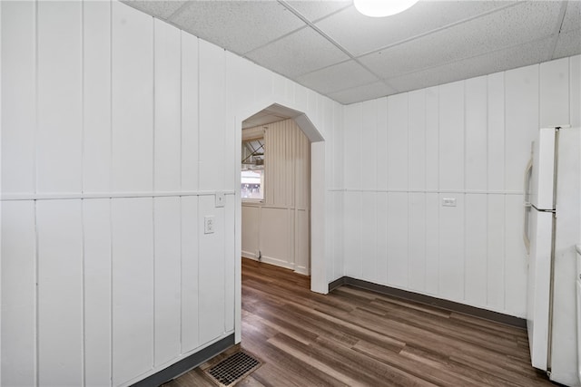 additional living space with wood walls and dark hardwood / wood-style flooring