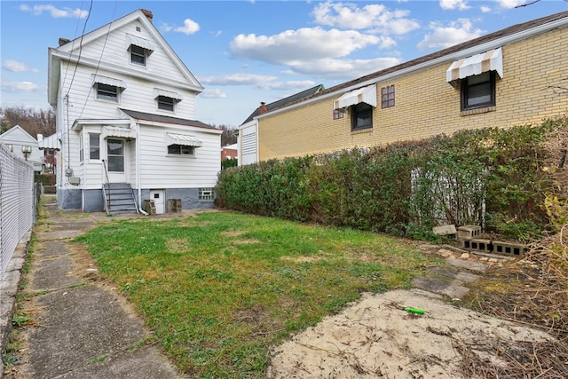 rear view of house with a lawn