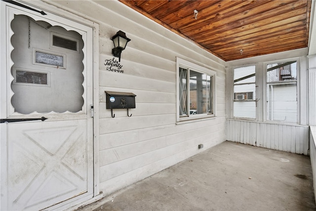 unfurnished sunroom featuring wooden ceiling