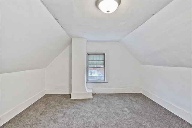 bonus room featuring carpet flooring and vaulted ceiling