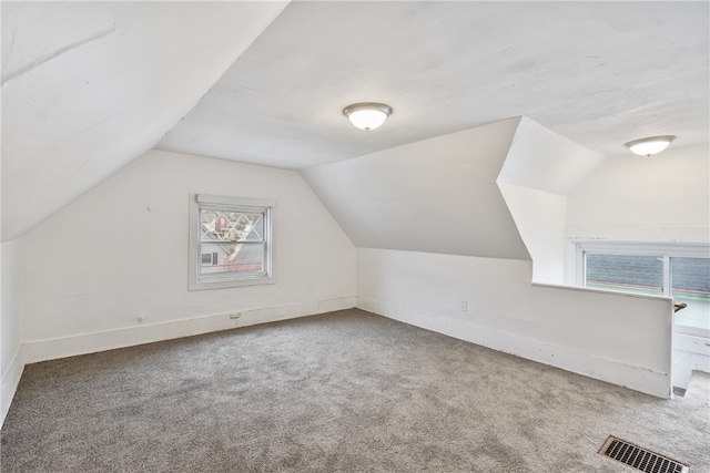 bonus room with carpet flooring and lofted ceiling