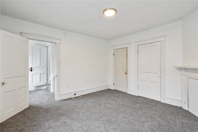 unfurnished bedroom featuring dark colored carpet