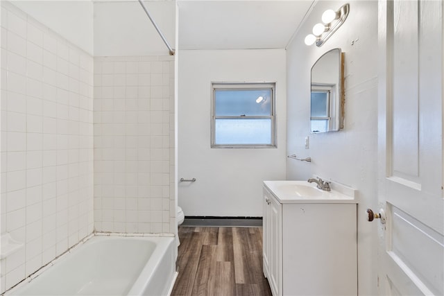 full bathroom featuring hardwood / wood-style flooring, vanity, toilet, and tiled shower / bath combo