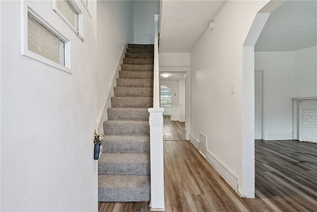 staircase featuring wood-type flooring