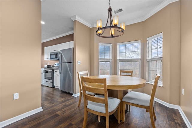 dining room featuring dark hardwood / wood-style flooring, an inviting chandelier, and crown molding