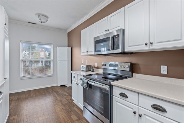 kitchen with white cabinets, dark hardwood / wood-style floors, ornamental molding, and stainless steel appliances