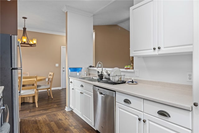 kitchen with sink, white cabinets, pendant lighting, and appliances with stainless steel finishes