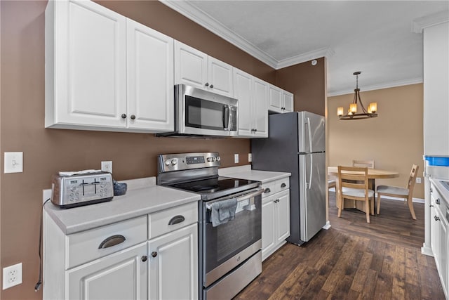 kitchen with appliances with stainless steel finishes, white cabinetry, dark wood-type flooring, and crown molding