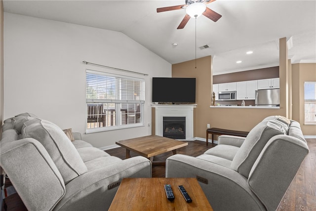 living room featuring hardwood / wood-style floors, ceiling fan, and lofted ceiling