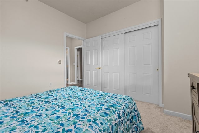 bedroom featuring light carpet and a closet