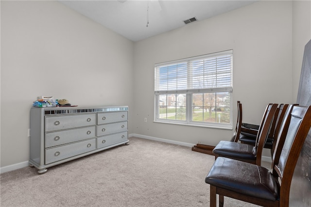 living area featuring light carpet and ceiling fan