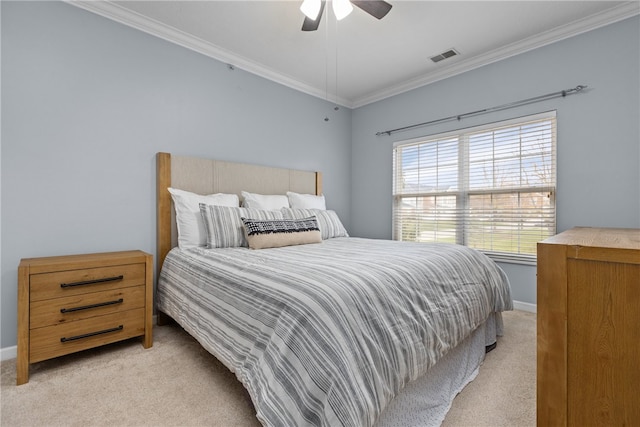 bedroom featuring ceiling fan, crown molding, and light colored carpet