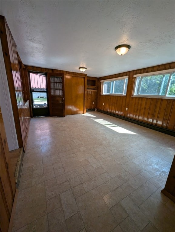 2225 Swallow Hill Rd, Scott Twp Sal, PA 15220 - unfurnished living room with wooden walls and a textured ceiling