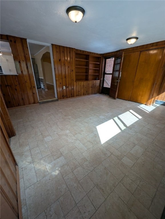 2225 Swallow Hill Rd, Scott Twp Sal, PA 15220 - unfurnished living room with wood walls and arched walkways