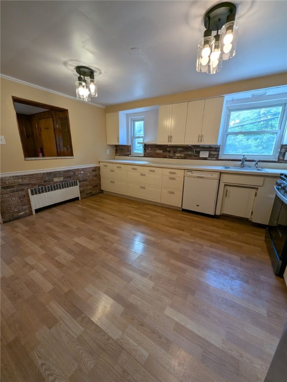 2225 Swallow Hill Rd, Scott Twp Sal, PA 15220 - kitchen with dishwasher, radiator, a sink, white cabinets, and a chandelier