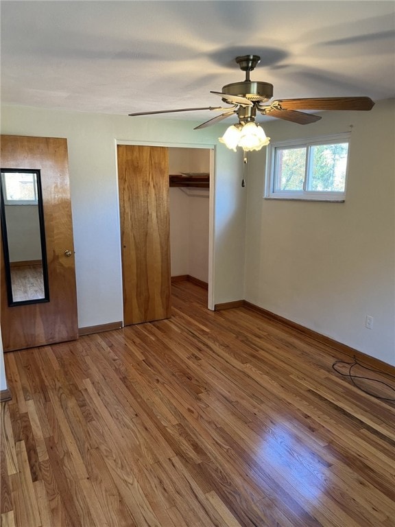 unfurnished bedroom featuring ceiling fan, baseboards, and wood finished floors