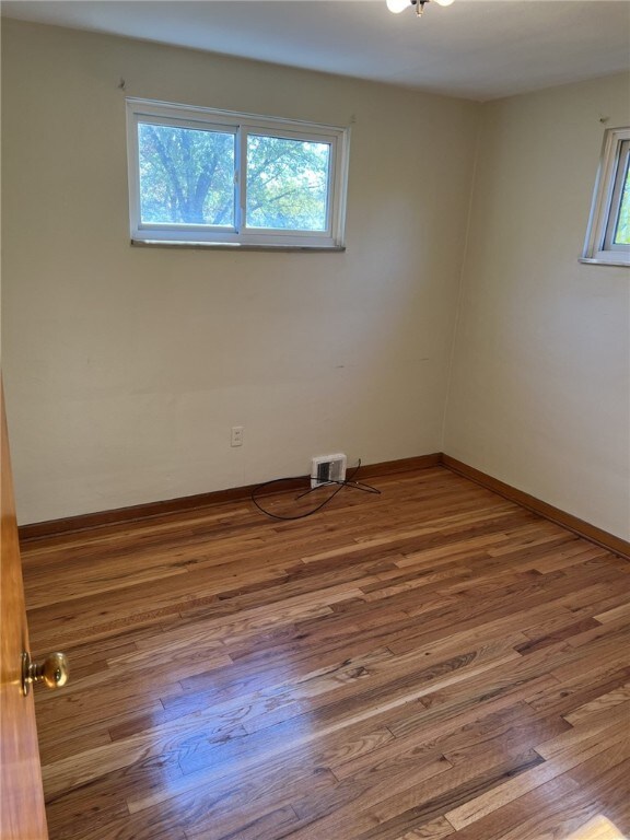 221 Sharon Dr, Forest Hills Boro, PA 15221 - empty room with wood finished floors and baseboards