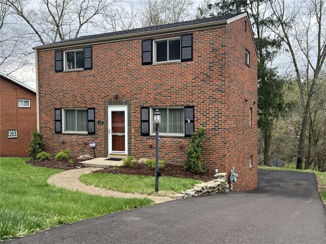 221 Sharon Dr, Forest Hills Boro, PA 15221 - view of front of home with brick siding, driveway, and a front yard