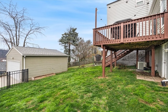 view of yard featuring cooling unit, a garage, an outdoor structure, and a wooden deck