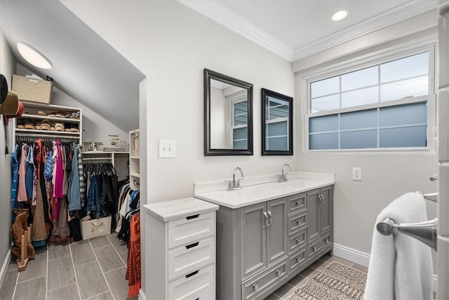 bathroom with vanity, ornamental molding, and lofted ceiling