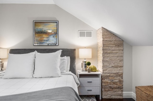 bedroom featuring light hardwood / wood-style floors and vaulted ceiling