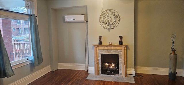 interior space with wood-type flooring, a fireplace, and a wall mounted AC