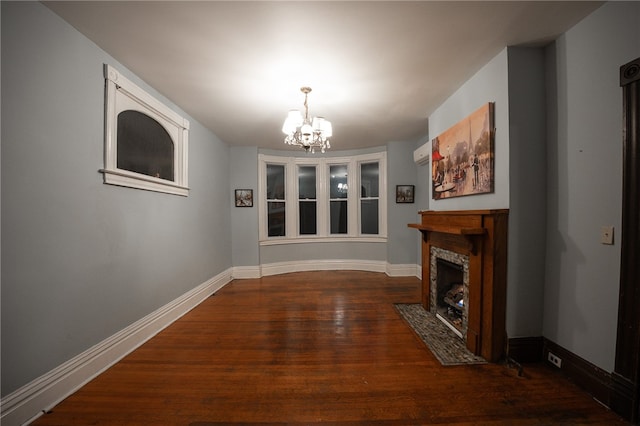 living room with a tile fireplace, dark hardwood / wood-style floors, and an inviting chandelier