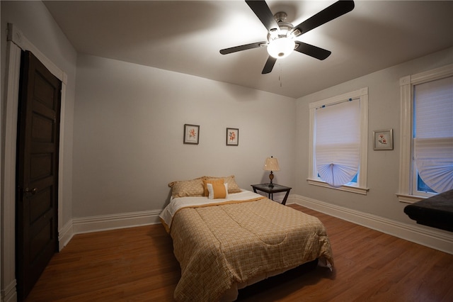 bedroom featuring ceiling fan and dark hardwood / wood-style floors