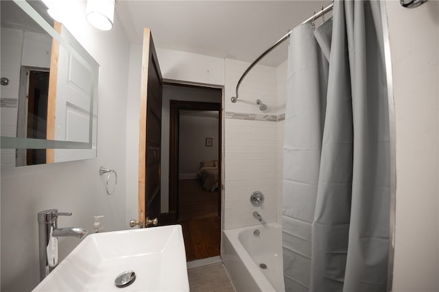 bathroom with sink and shower / bathtub combination with curtain