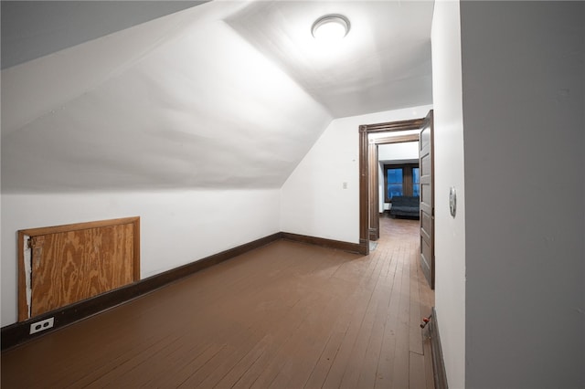 additional living space featuring hardwood / wood-style flooring and vaulted ceiling