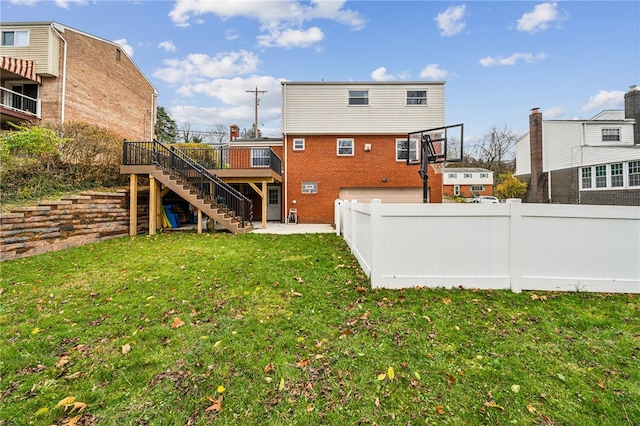 back of house with a lawn and a deck