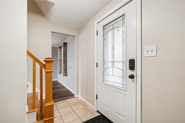 foyer entrance featuring light tile patterned flooring