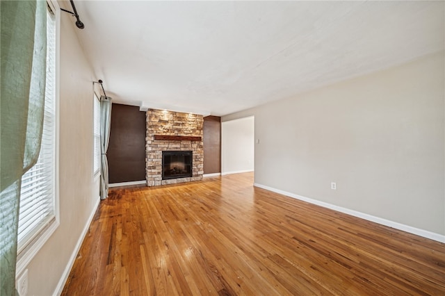 unfurnished living room featuring hardwood / wood-style floors and a fireplace