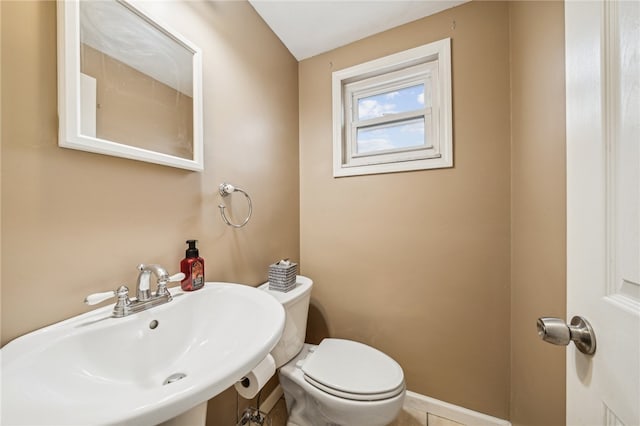 bathroom featuring sink, tile patterned flooring, and toilet