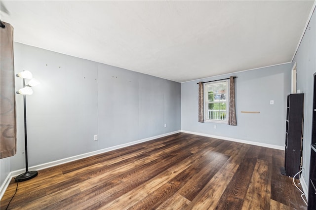 spare room with dark hardwood / wood-style floors