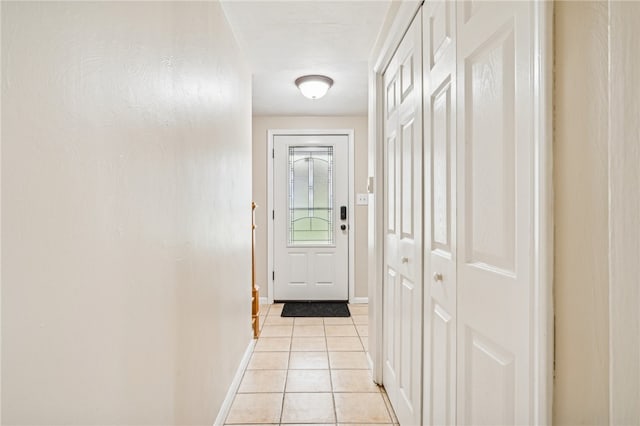 doorway to outside with light tile patterned flooring