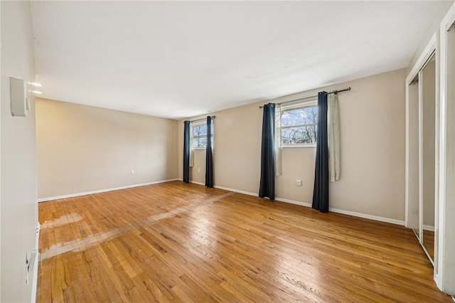 unfurnished bedroom with a closet and light hardwood / wood-style flooring