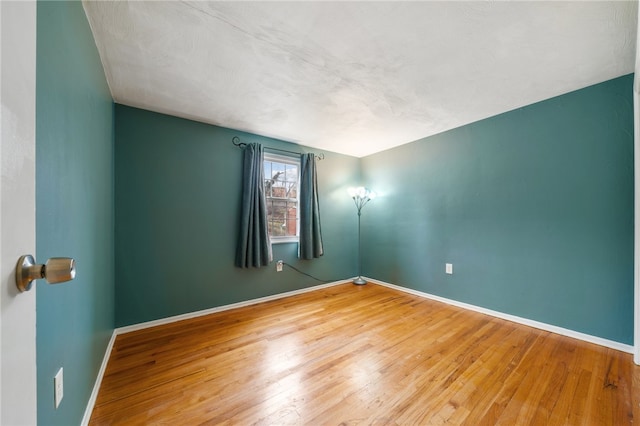 empty room with hardwood / wood-style floors