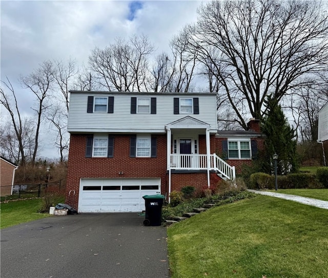 view of front of property featuring a garage and a front lawn