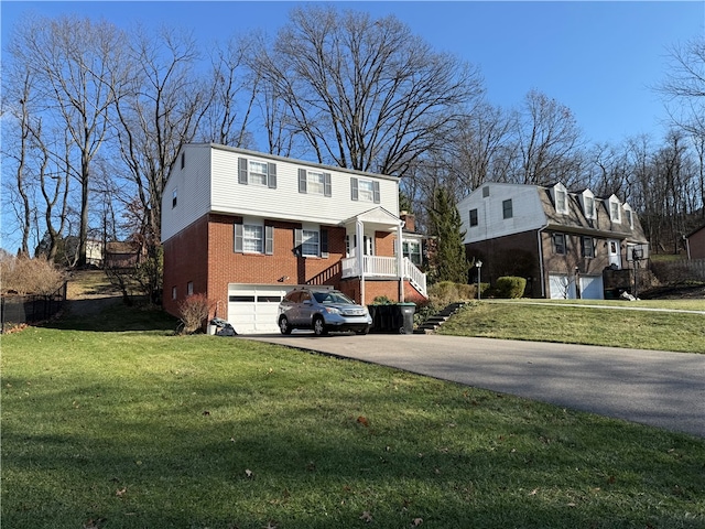 view of front of home featuring a front yard and a garage