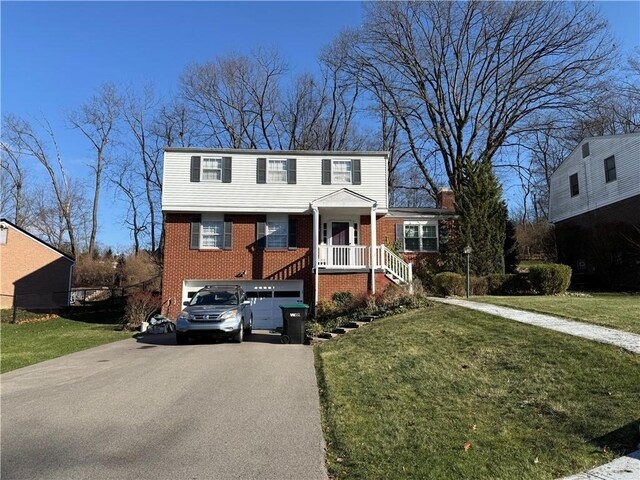 view of front facade with a front yard and a garage