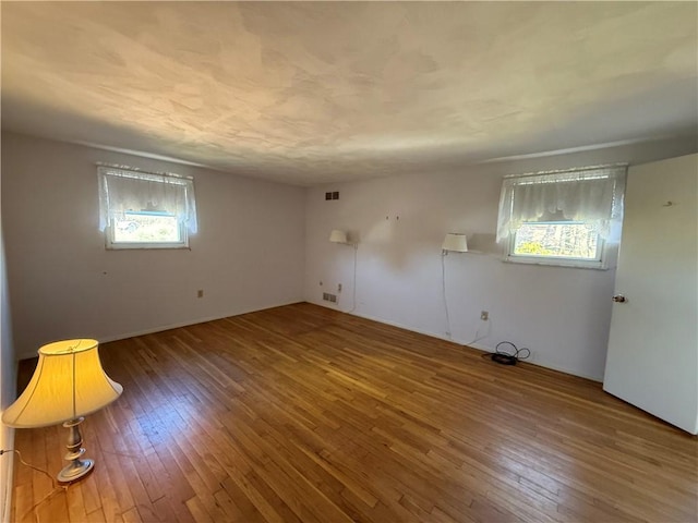 spare room with hardwood / wood-style flooring