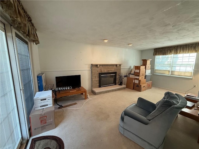 living room featuring a fireplace and light colored carpet