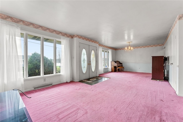 entryway featuring light carpet, french doors, and a notable chandelier