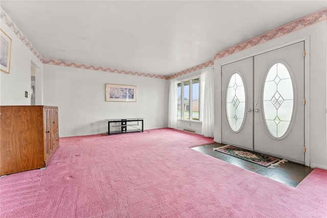 carpeted foyer featuring french doors