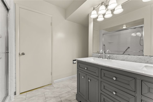 bathroom featuring a shower with door, vanity, and a notable chandelier